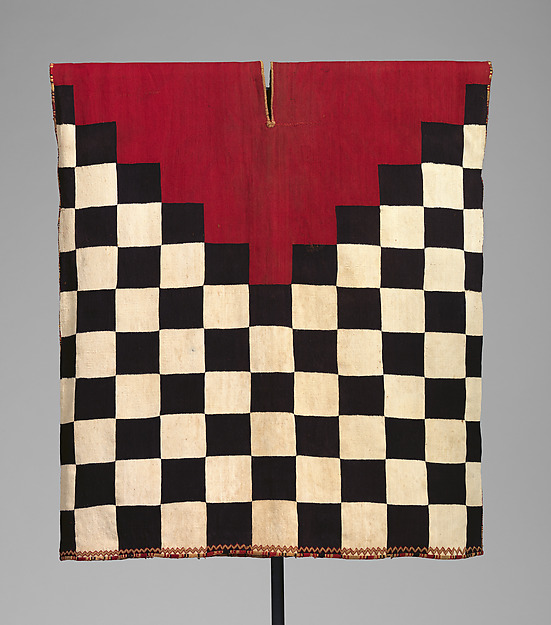 Black-and-white checkerboard Inca tunic with a red V-shaped yoke