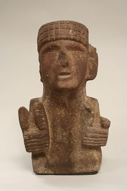 Basalt Mexica sculpture of the maize deity Chicomecoatl holding ears of corn