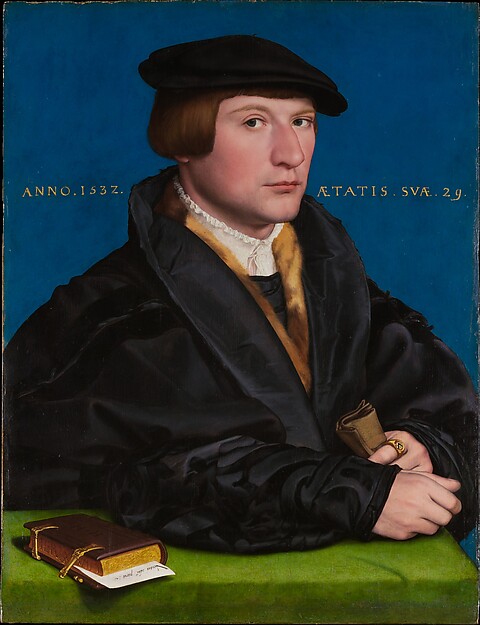 Renaissance portrait of a German merchant seated beside a book