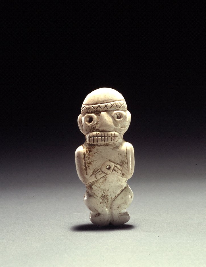 Small Taíno amulet carved from shell in the shape of a human-like figure